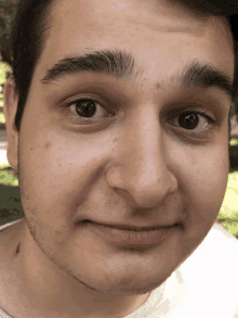 a close up of a young man 's face with a beard