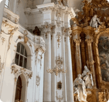 a church with columns and statues on the altar