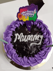 a birthday cake with purple frosting and the name mummy written on it