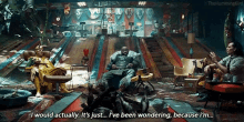 a group of men are sitting in chairs in front of a bowling alley talking to each other .
