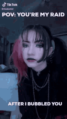 a girl with pink and black hair is wearing a black shirt and a choker .