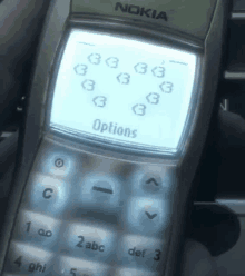 a person is holding a nokia phone with options displayed