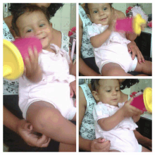 a baby in a pink bodysuit is playing with a toy