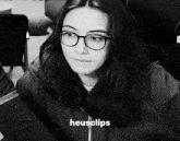 a black and white photo of a woman with glasses and the word heusclips