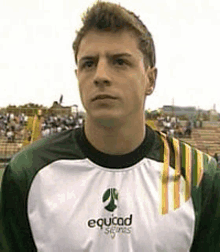 a man wearing a shirt that says equidad sports on it