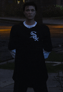 a man wearing a black shirt with a white s on it