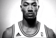 a black and white photo of a basketball player wearing an adidas shirt