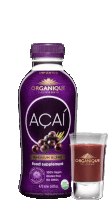 a bottle of organic açai premium blend food supplement next to a shot glass