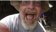 a man with a beard wearing a hat and glasses