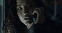 a woman talking on a cell phone in the dark