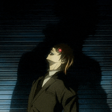 a man in a suit has red eyes and a shadow behind him