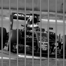 a black and white photo of a mclaren racing car