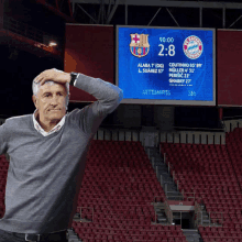 a man stands in front of a scoreboard which shows a score of 2 : 8