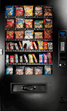 a vending machine filled with snacks including doritos lays and snickers