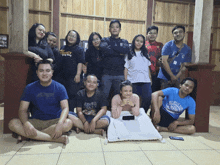 a group of people posing for a picture with one wearing a t-shirt that says army