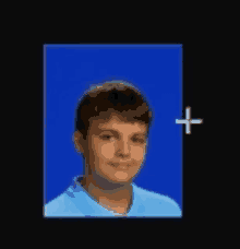 a boy in a blue shirt is standing in front of a blue background with a white cross .