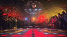 a man is dancing on a dance floor in front of a crowd