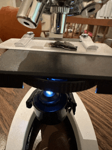 a close up of a microscope with a blue light on