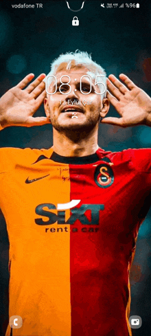 a man in a sixt rent a car jersey holds his hands over his face