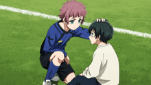 a boy in a blue shirt is kneeling next to another boy