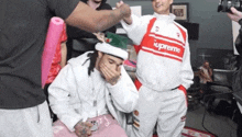 a man wearing a santa hat and a supreme sweatshirt