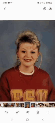 a woman wearing a red sweater with the letter t on it