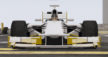 a man is sitting in a white race car