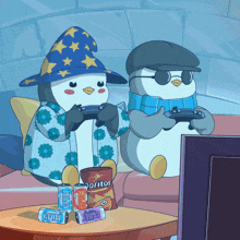 two penguins are playing a video game with a bag of doritos