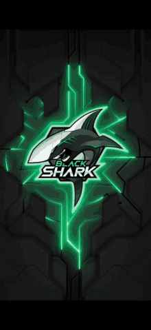 a black shark logo that is glowing green