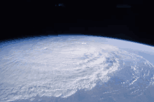 a view of the earth from space with a hurricane in the background