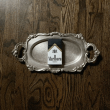 a pack of marlboro cigarettes sitting on a silver tray