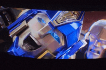 a close up of a robot with blue eyes on a television screen