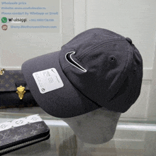 a louis vuitton wallet sits next to a nike hat on a table