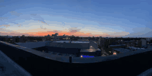 a sunset over a city with a building that says microsoft on it