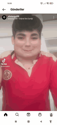 a man in a red shirt is smiling on a tiktok video