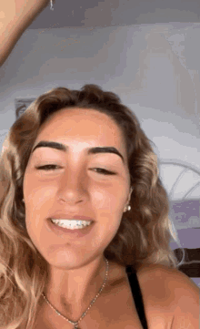 a woman with braces on her teeth is smiling for the camera