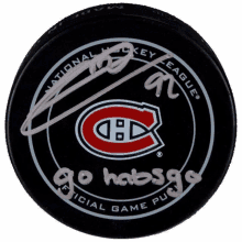 a signed hockey puck that says go habsga on it