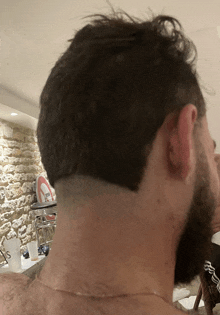 the back of a man 's head with a shaved line in his hair