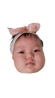 a baby wearing a headband with a pink bow on it