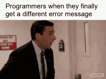 a man in a suit and tie is standing in front of a door with a different error message .