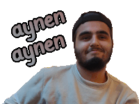 a man with a beard is wearing a white shirt and a black hat and has aynen aynen written on his face