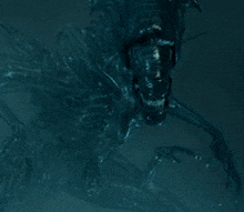 a close up of a monster in the dark with a blue background