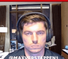 a man wearing headphones and a shirt that says maxverstappen1 on it