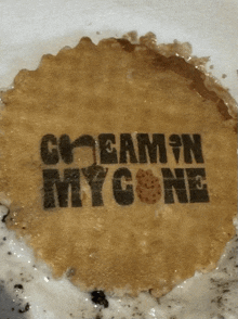 a cookie that has the words creamin my cone written on it