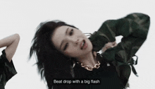 a woman is dancing in a video with the words `` beat drop with a big flash '' written on the screen .