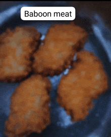 a close up of fried food with the word baboon meat above it