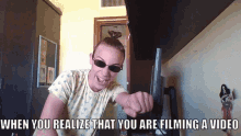 a woman wearing sunglasses pointing at the camera with the caption when you realize that you are filming a video