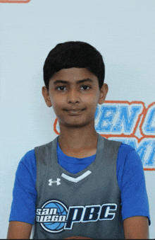 a young boy in a san diego pbc jersey poses for a picture