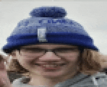 a blurry picture of a person wearing a blue beanie