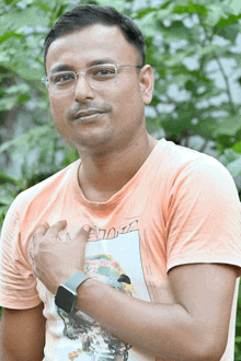 a man wearing glasses and a t-shirt with a picture of a man on it